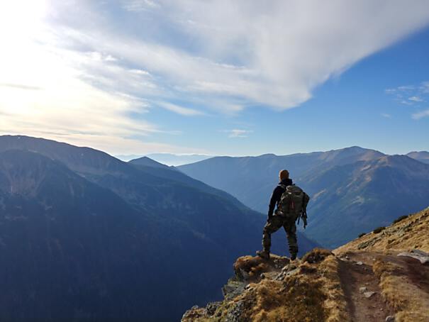 Man on a mountain summit - Photo by Wojciech Then on Unsplash