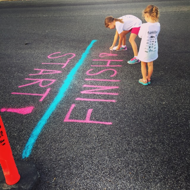 Two girls spraying the same line for start and finish - Photo by Aw Creative on Unsplash